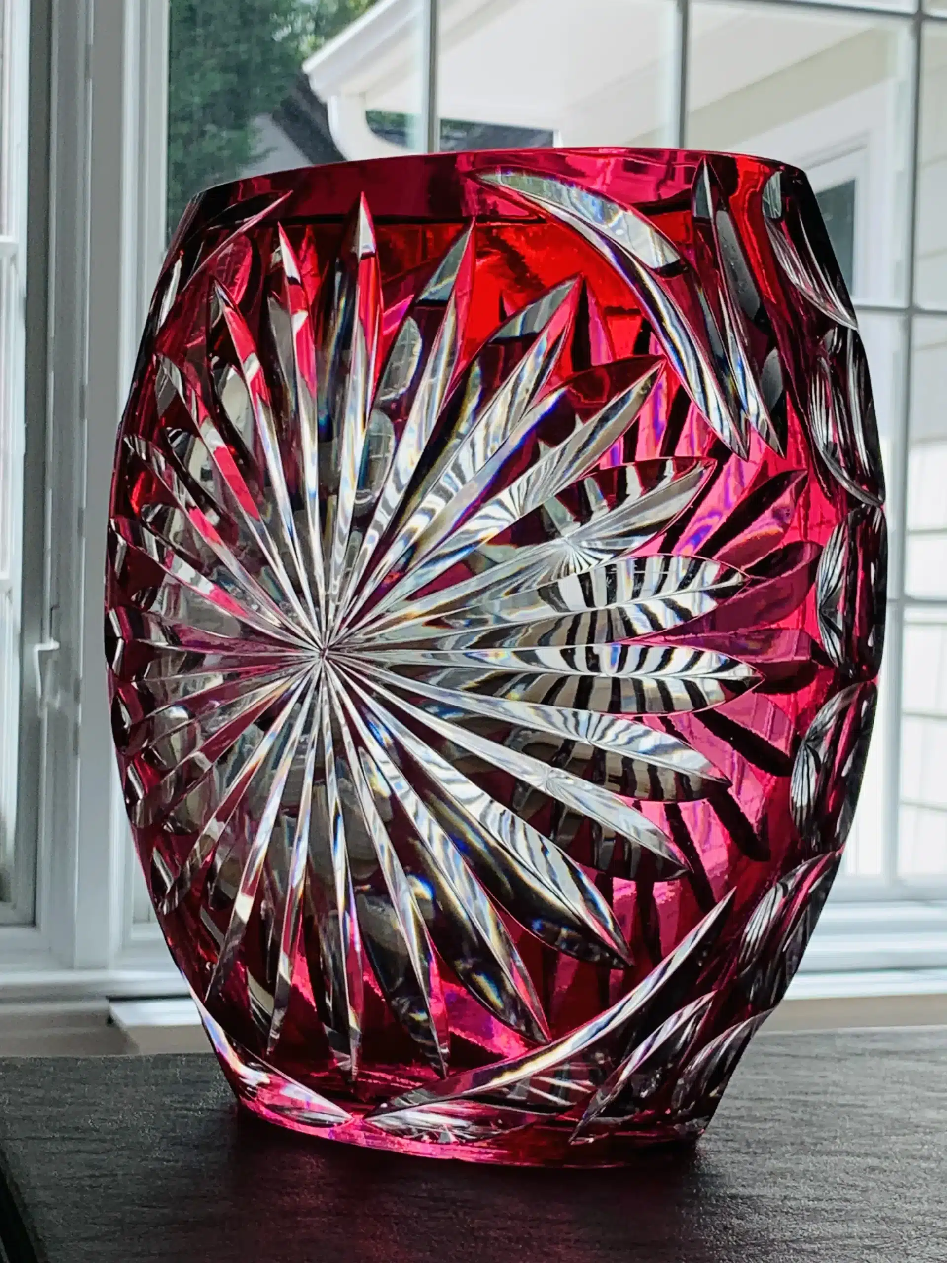 Red decorative glass vase with intricate patterns.