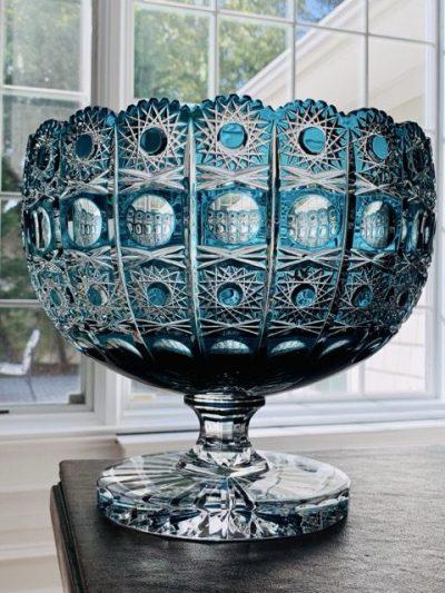 Intricately designed blue glass pedestal bowl with detailed patterns.
