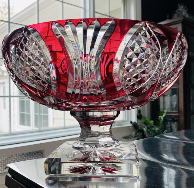Elegant red and clear cut glass bowl on a pedestal.