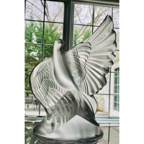 Intricately carved green glass bowl with floral patterns.